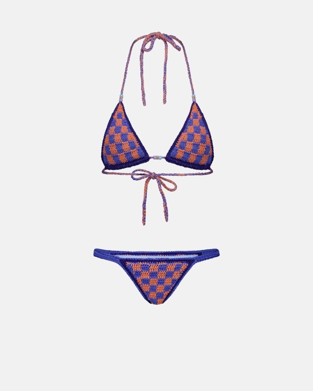 A top-down flat lay view of the Aura crochet bikini set in electric blue and orange checkerboard, showing the bead details on the ties against a clean white background.