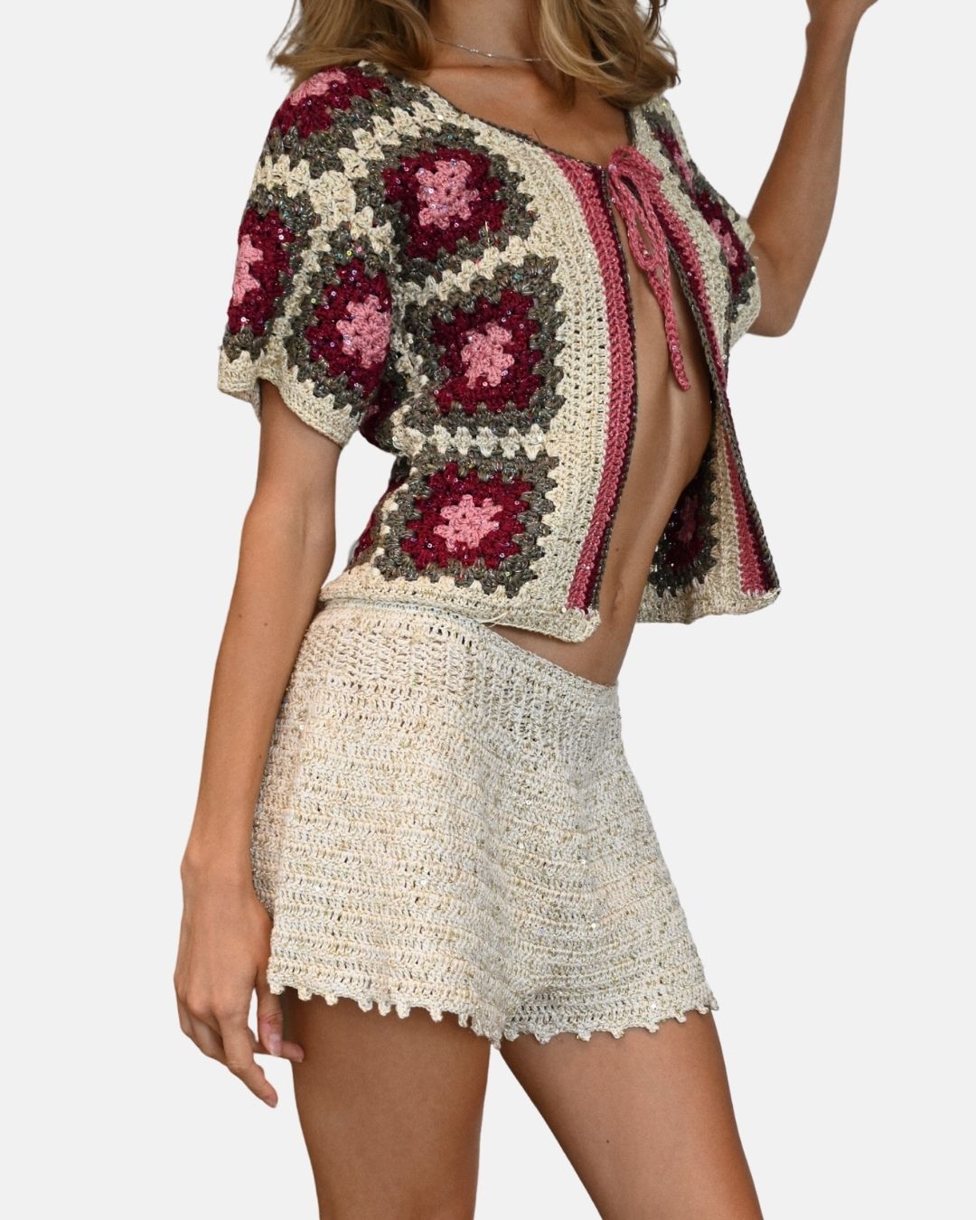 Side profile of the Sarah sequined cardigan, showcasing the sleeve volume and the artisan texture of the hand-crocheted squares.