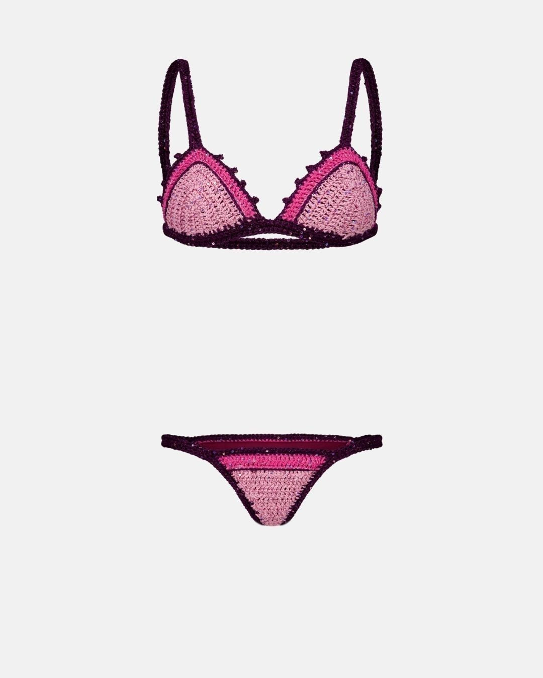 A studio flat lay of the Sicily crochet bikini set in powder pink and plum, showcasing the scalloped triangle top and matching bottoms.